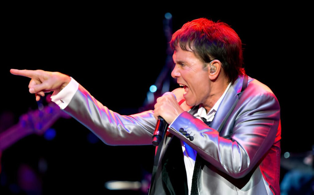 Cliff Richard Concert Live at Royal Albert Hall – A Night of Timeless Music. Cliff Richard performing live at the Royal Albert Hall with elegant stage lighting and an enthusiastic