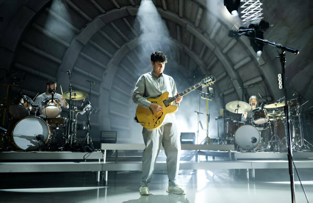 Vampire Weekend Concert Live at Hammersmith Apollo – Experience an Unforgettable Performance. Vampire Weekend performing live at Hammersmith Apollo with vibrant stage lights and an energetic crowd.