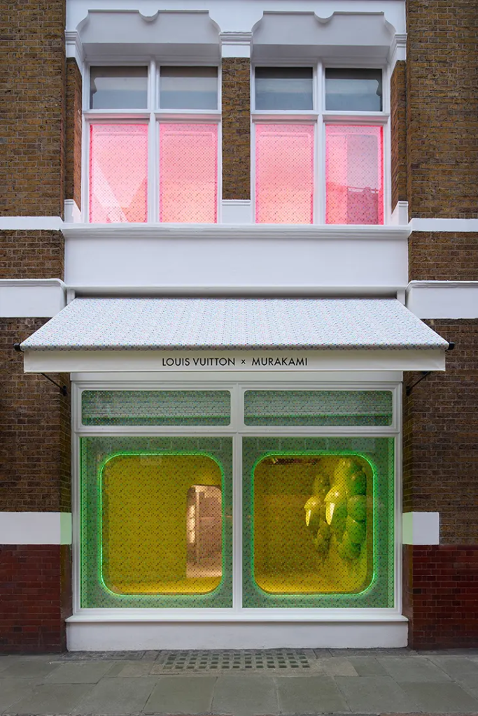 Exterior view of Louis Vuitton x Murakami pop-up café in Soho, London, with vibrant door signage and artistic entrance design Exterior view of Louis Vuitton x Murakami pop-up café in Soho, London, featuring the entrance door with vibrant signage and artwork