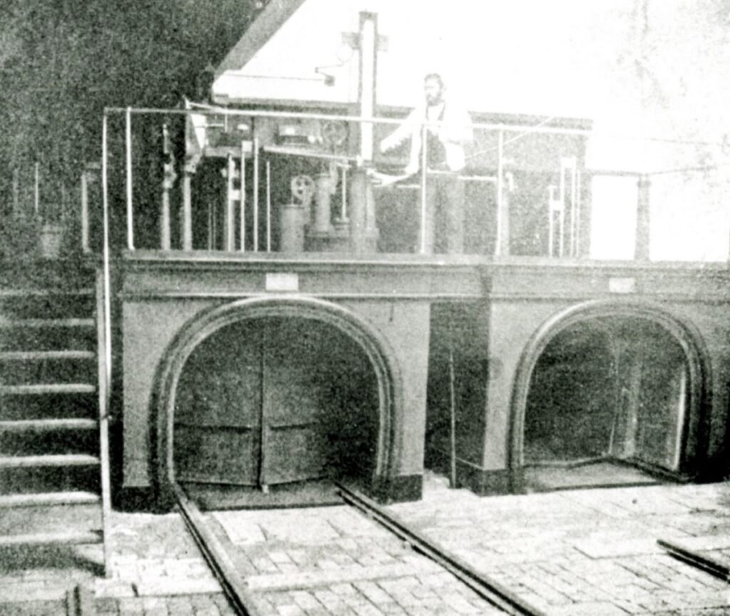 19th-Century Pneumatic Mail System at The Postal Museum An underground railway tunnel with vintage mail carts used for postal delivery