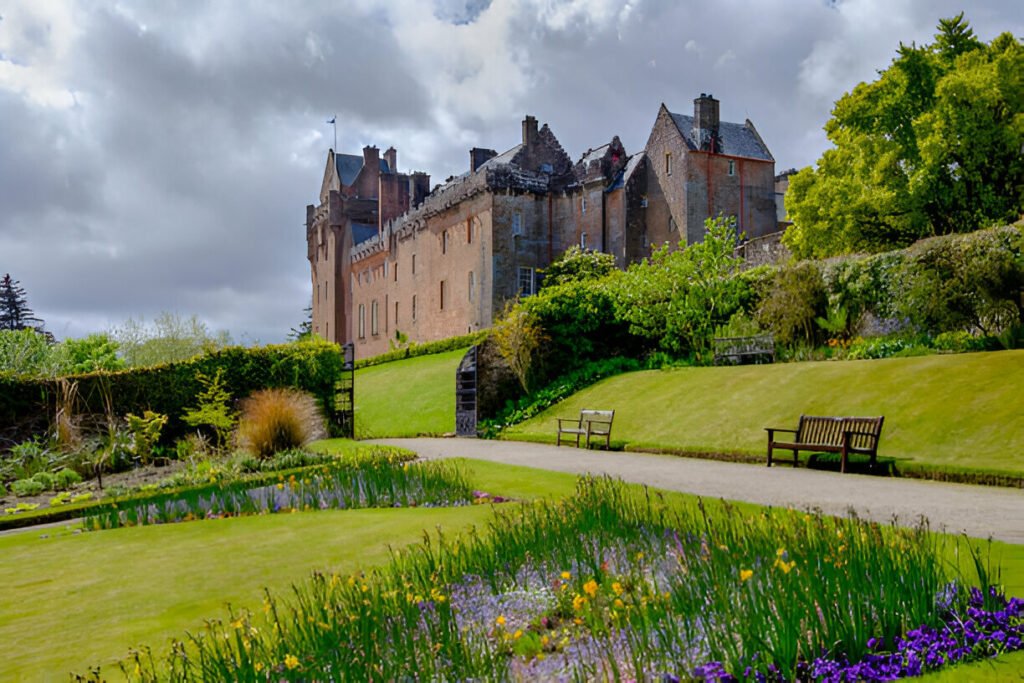 Brodick Castle on the Isle of Arran, Scotland, a historic landmark with beautiful gardens and scenic surroundings. Historic Brodick Castle surrounded by lush greenery on the Isle of Arran, Scotland, UK.