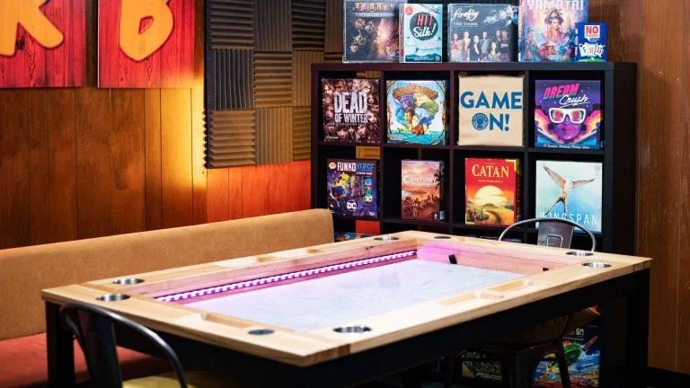 Draughts Board Game Café London A cozy board game café with shelves full of games and vibrant street art
