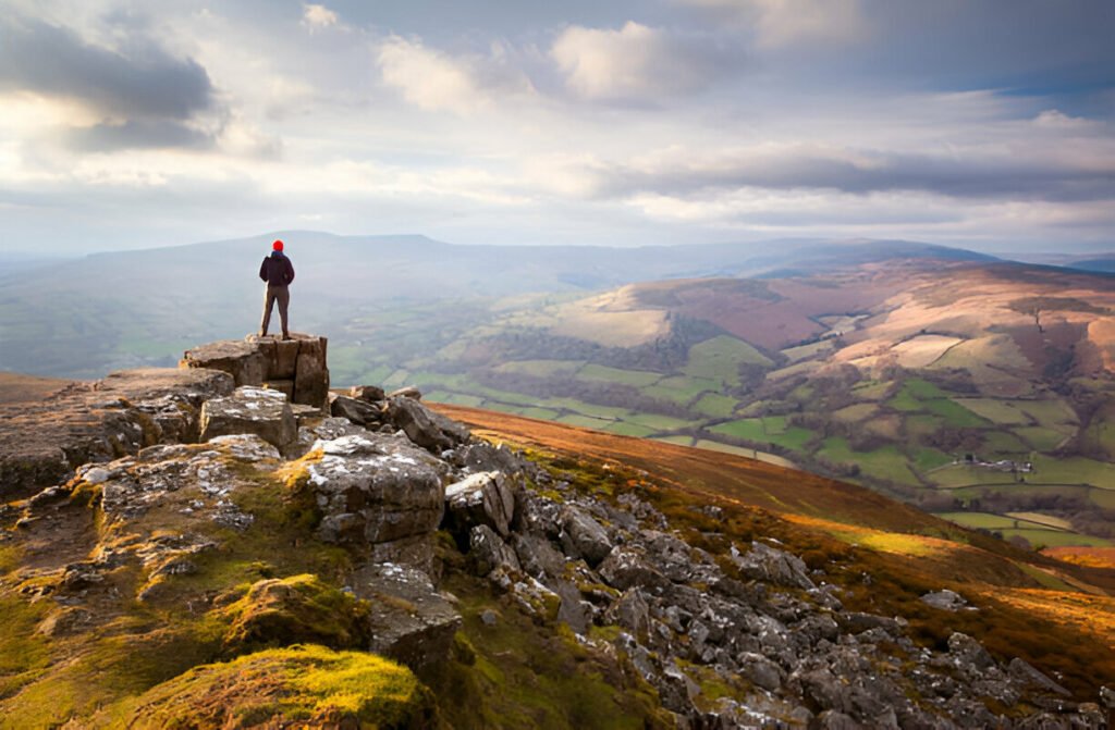 Hikers enjoying scenic mountain trails at Brecon Beacons National Park, Wales, UK – explore top UK travel spots with HouseToMotive Scenic view of hikers exploring the mountains at Brecon Beacons National Park, Wales, UK – a must-visit destination for nature lovers