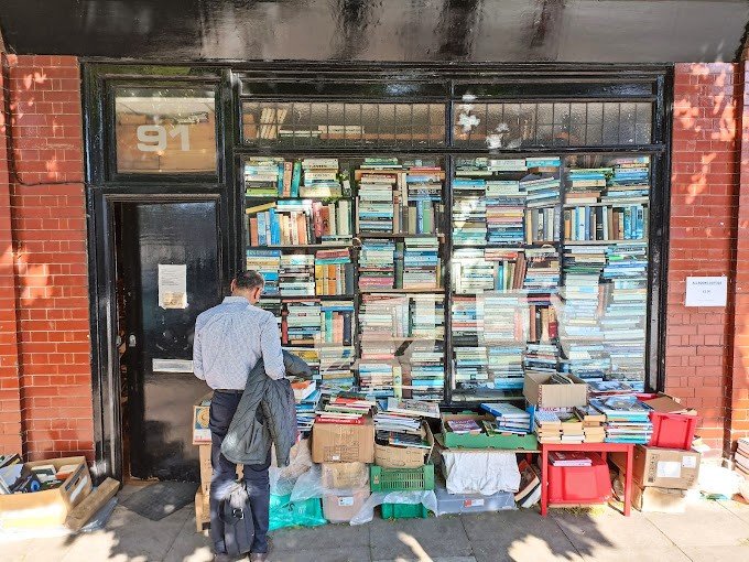 Hurlingham Books – A Bookstore with 2 Million Books A narrow bookstore filled with stacks of books from floor to ceiling
