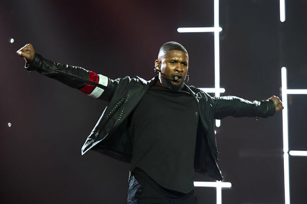 Usher concert UK 2025 – Usher performing live on stage at The O2 Arena in London with bright lights and a cheering crowd