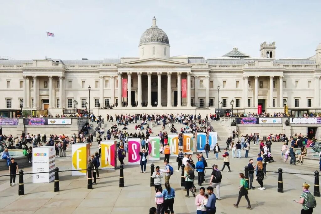 People enjoying free game demos and arcade games at London Games Festival 2025 in Trafalgar Square