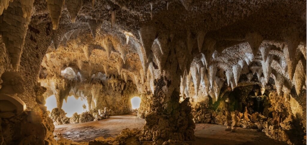 The Crystal Grotto – A magical hidden gem near London for a unique day trip A stunning view of The Crystal Grotto at Painshill Park, featuring sparkling crystal formations, rocky walls, and a magical cave-like setting.