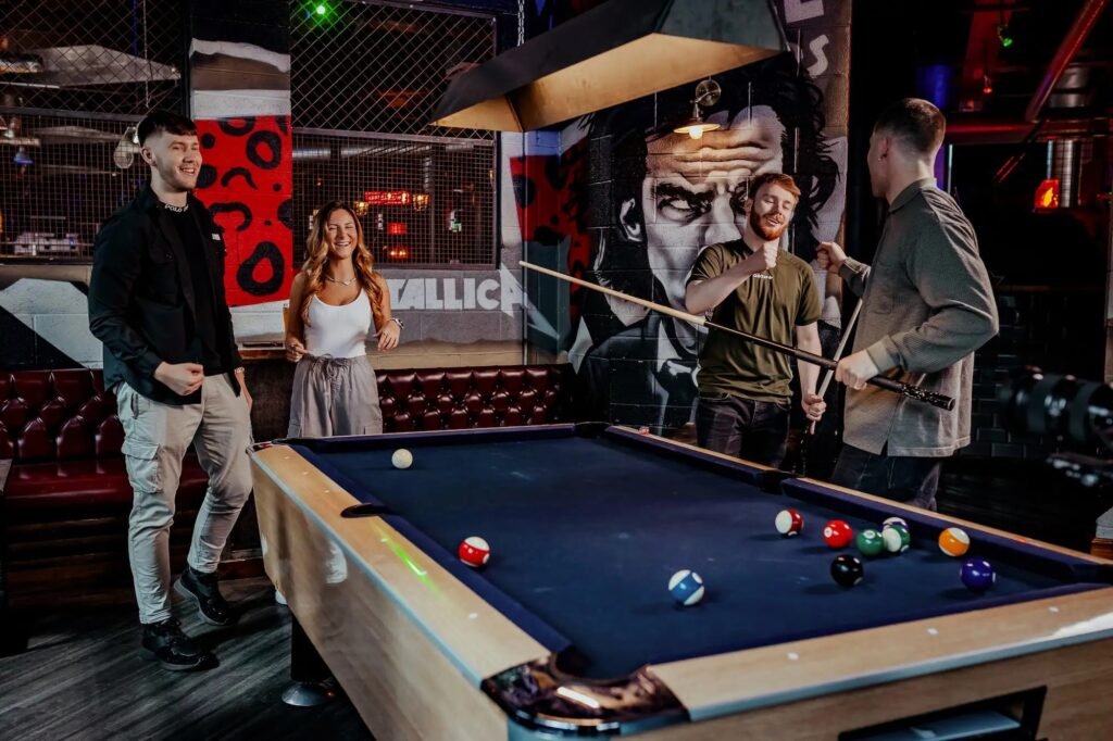 People enjoying crazy pool in London at Roxy Ball Room, 33 St Mary Axe – a fun indoor activity mixing pool and crazy golf